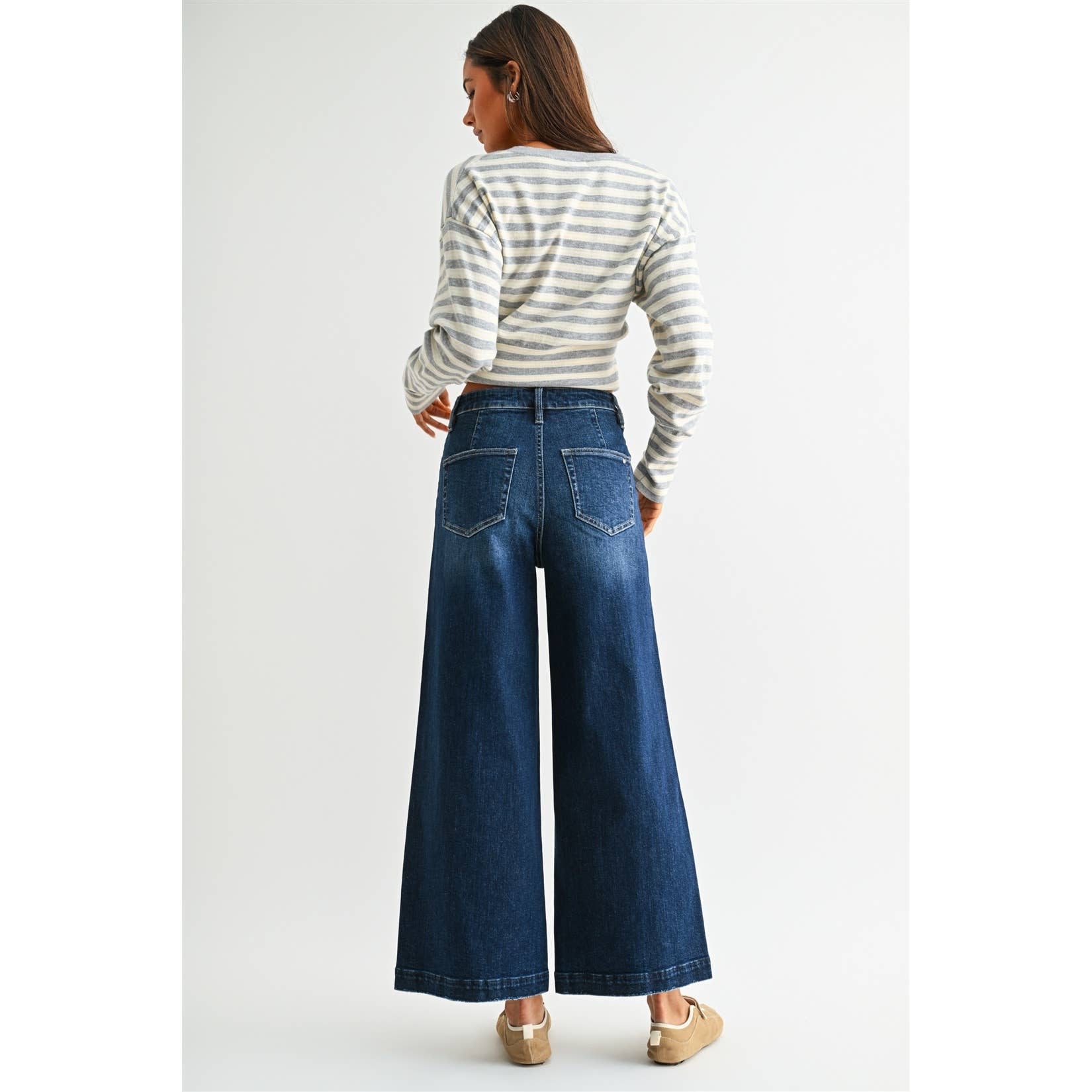 Annie Ks Boutique dark wash high-rise wide leg crop jeans worn by a model from the back view