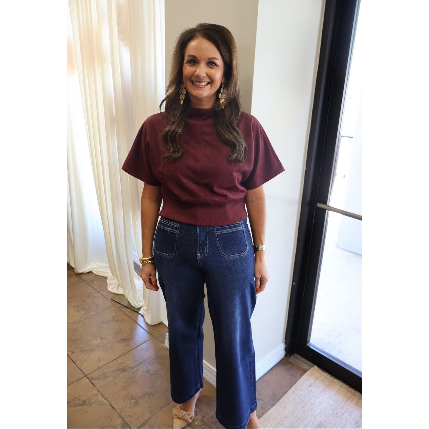 Annie Ks Boutique dark wash high-rise wide leg crop jeans worn by a woman with a burgundy top and gold jewelry