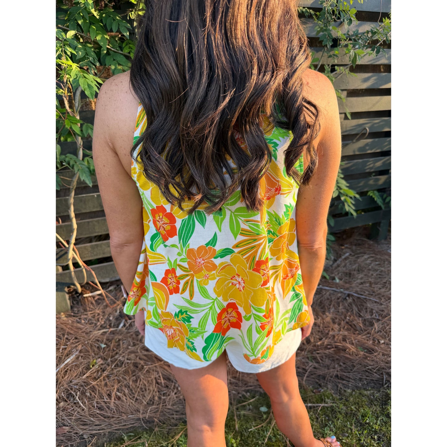 Annie Ks Boutique Island Sun Linen Halter top featuring a vibrant yellow, orange, and green floral print on a model.