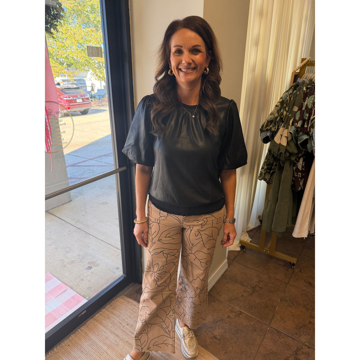 Annie Ks Boutique model wearing high-rise cropped wide-leg jeans with a black and white floral line art print.