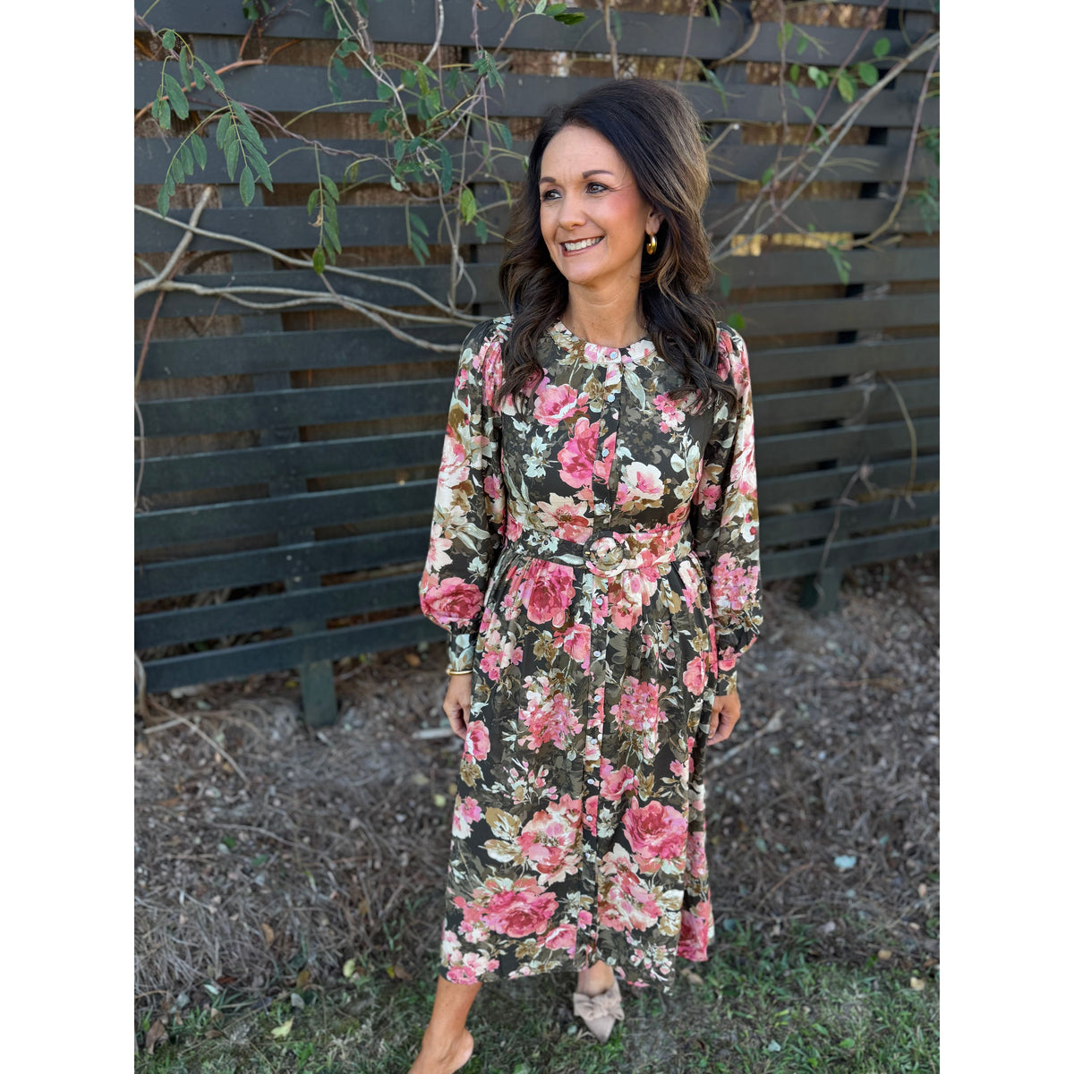 Annie Ks Boutique forest green maxi dress with pink floral print, long sleeves, and button-down front on a woman