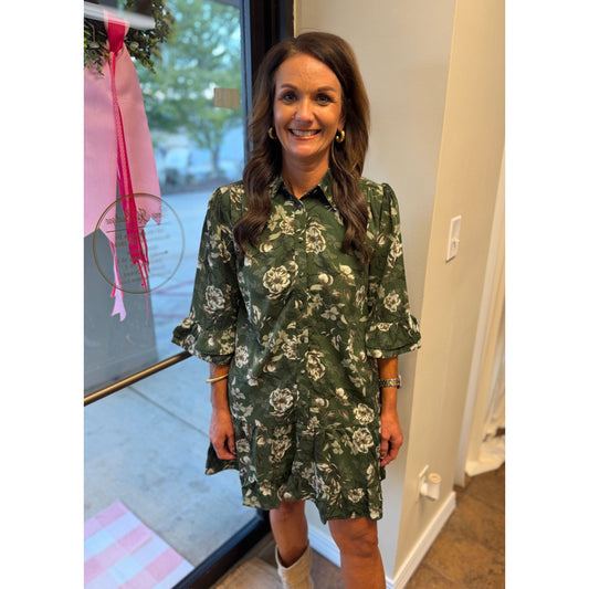 Annie Ks Boutique green floral mini dress with ruffle sleeves, button-down front, and patch pockets on a woman