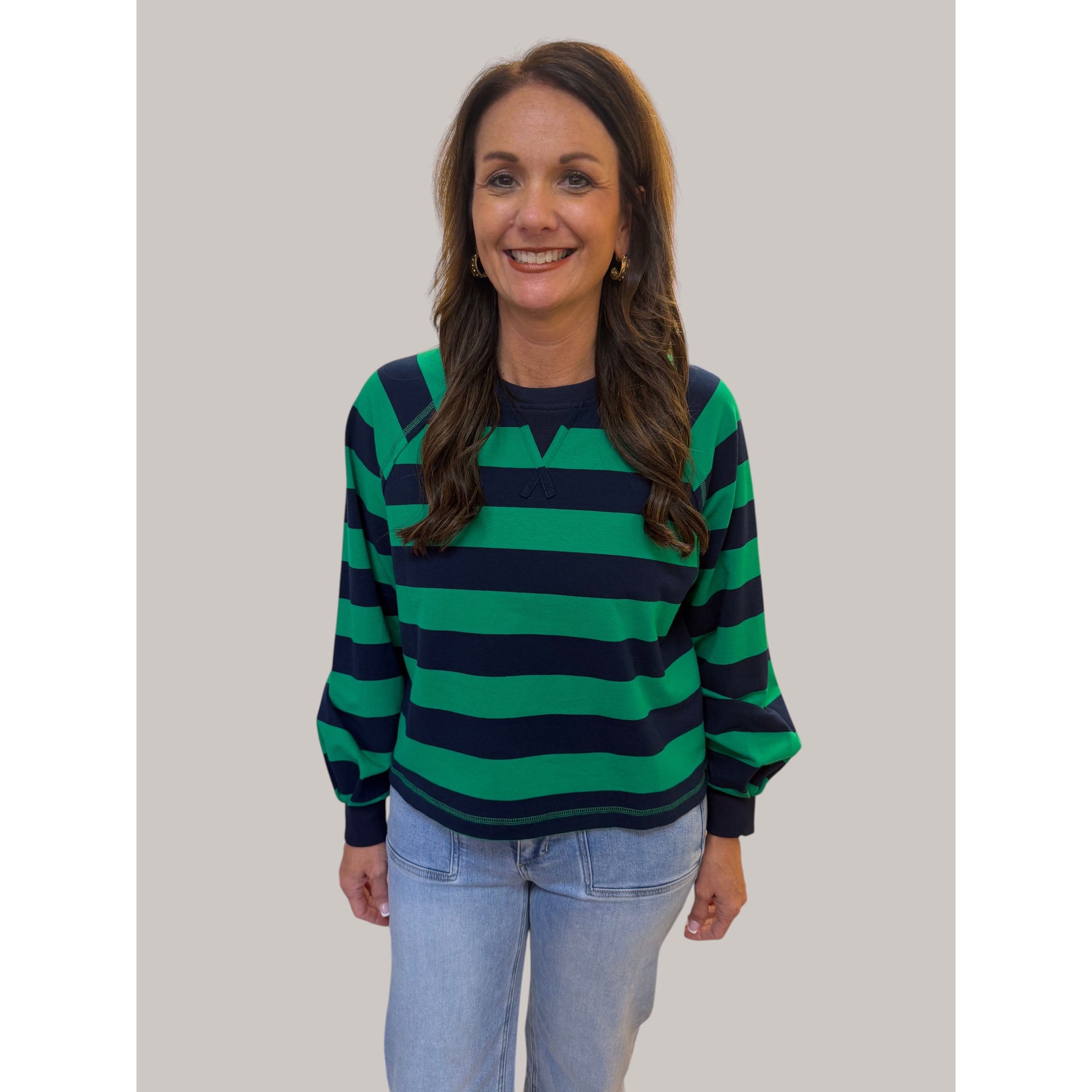 Annie Ks Boutique green and navy striped raglan top with drawstring neckline and ribbed cuffs worn by a smiling woman