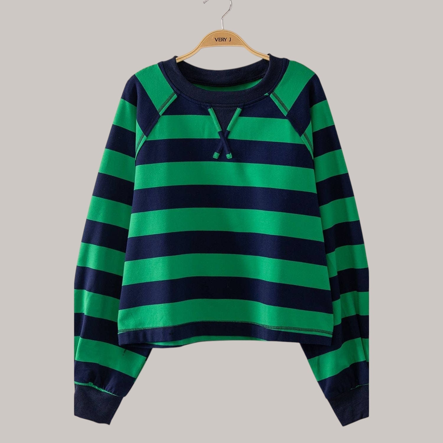 Annie Ks Boutique green and navy striped cotton blend top with raglan sleeves and a drawstring round neckline.