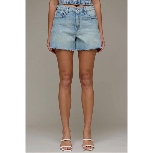 Annie Ks Boutique high-rise denim shorts in a light vintage wash with a raw hem and relaxed A-line fit on a model.