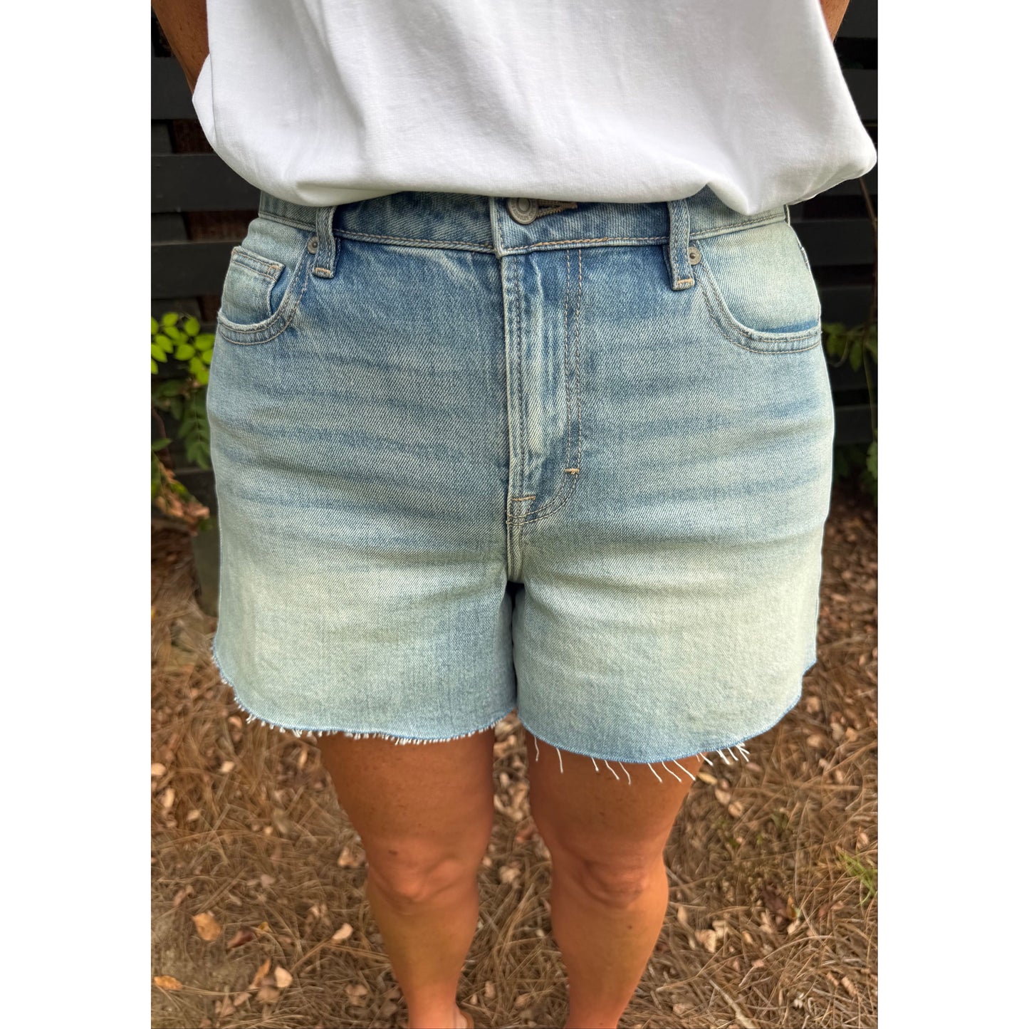 Annie Ks Boutique high-rise denim shorts in a light vintage wash with a raw hem and relaxed A-line fit.