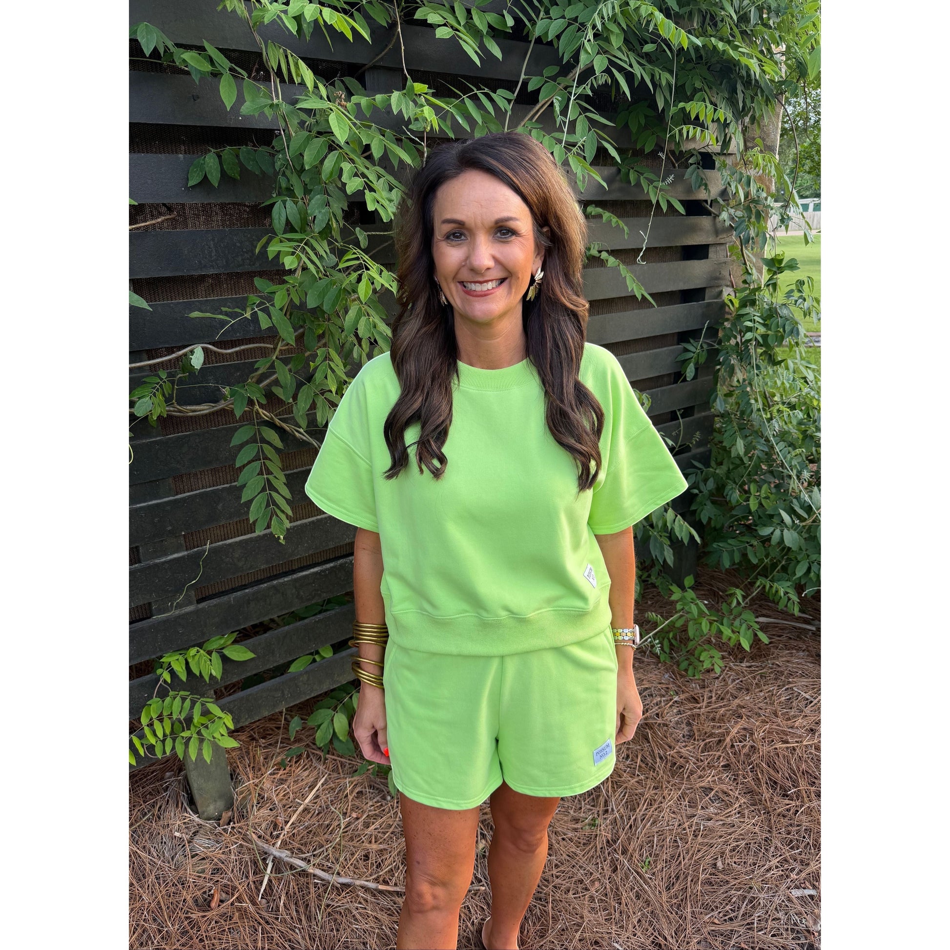 Annie Ks Boutique Key Lime short set in heavyweight cotton blend knit worn by a woman outdoors.