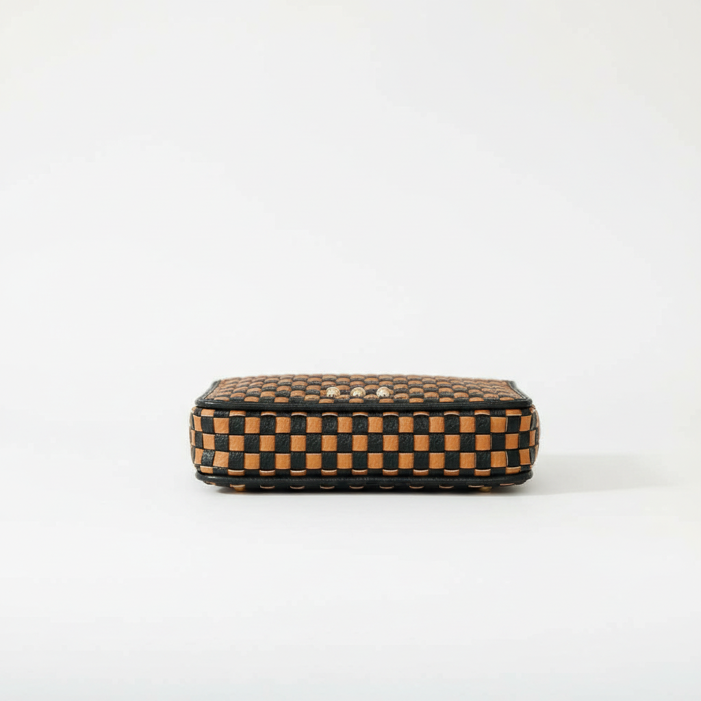 Annie Ks Boutique Lenni large zip wallet in woven checkered coffee vegan leather, shown from a side profile view.