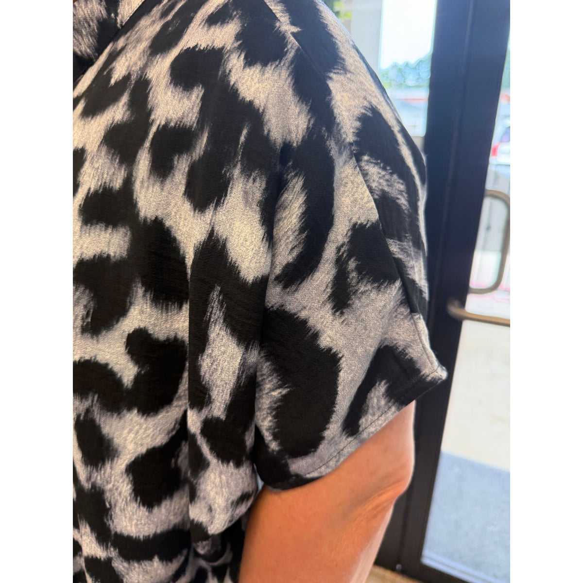 Annie Ks Boutique black and grey leopard print mock neck blouse with short sleeves and lightweight viscose drape