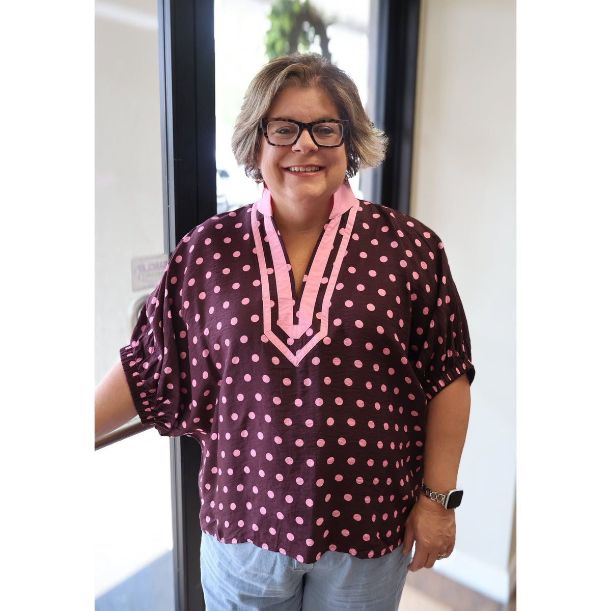 Annie Ks Boutique curvy merlot polka dot dolman top with a pink contrast V-neck collar and elasticated sleeves.