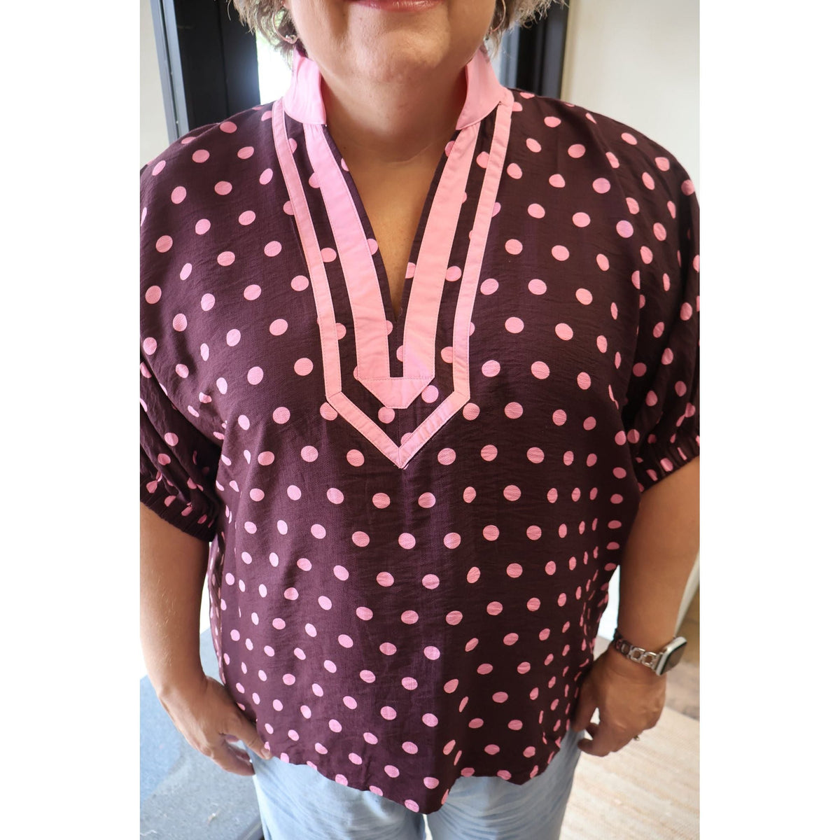 Annie Ks Boutique curvy merlot polka dot dolman top with a pink contrast V-neck collar and elasticated sleeves.