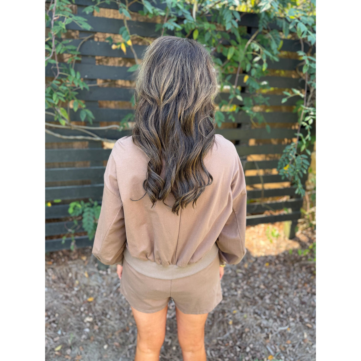 Annie Ks Boutique mocha lounge set featuring a cropped sweatshirt and shorts worn by a woman from the back view