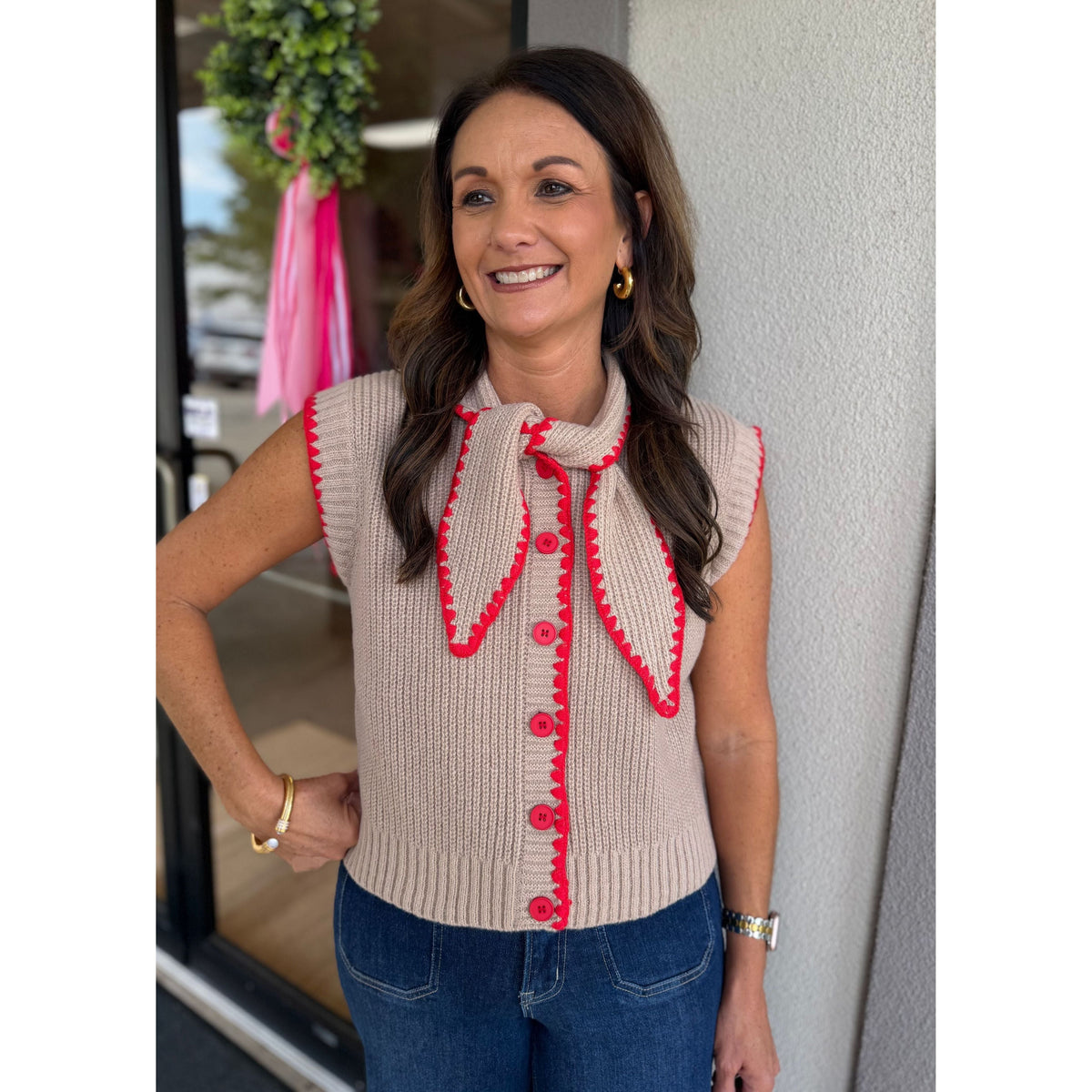 Annie Ks Boutique mocha sweater vest with red contrast blanket stitching, button-down front, and tie-neck detail.