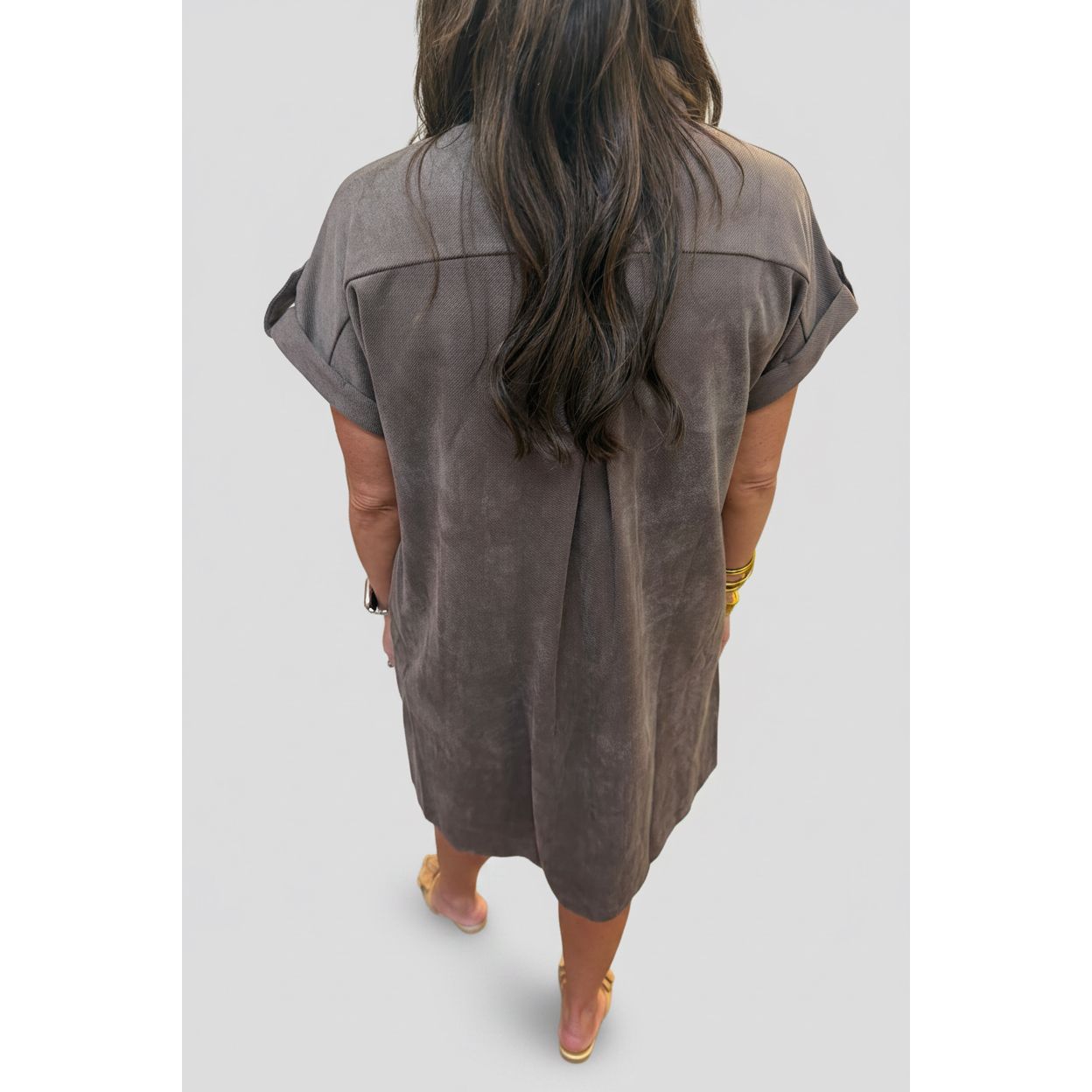 Back view of a woman wearing an Annie Ks Boutique mocha faux suede shirt dress with cuffed short sleeves