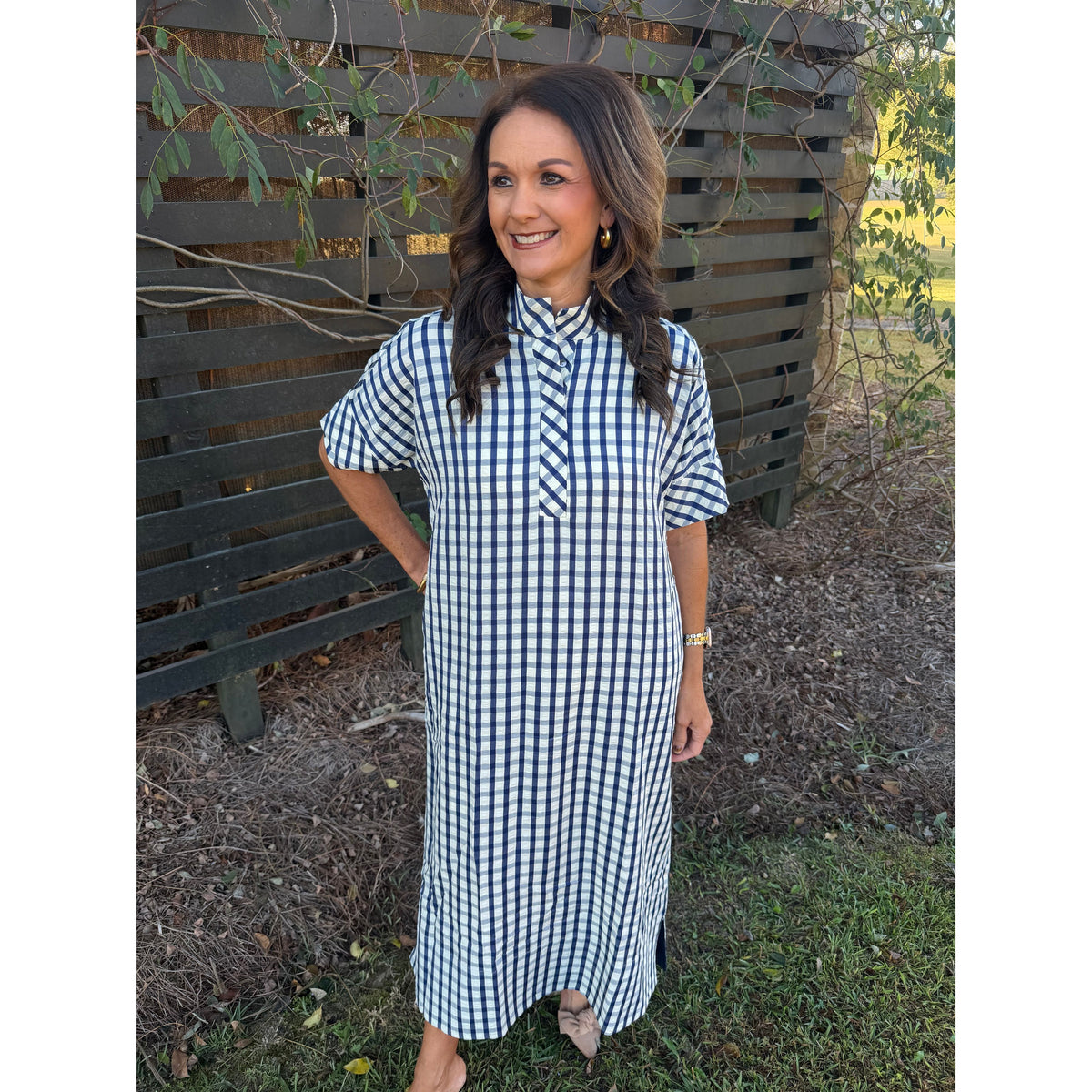 Annie Ks Boutique navy and white gingham midi dress with shirt collar and short sleeves worn by a smiling woman