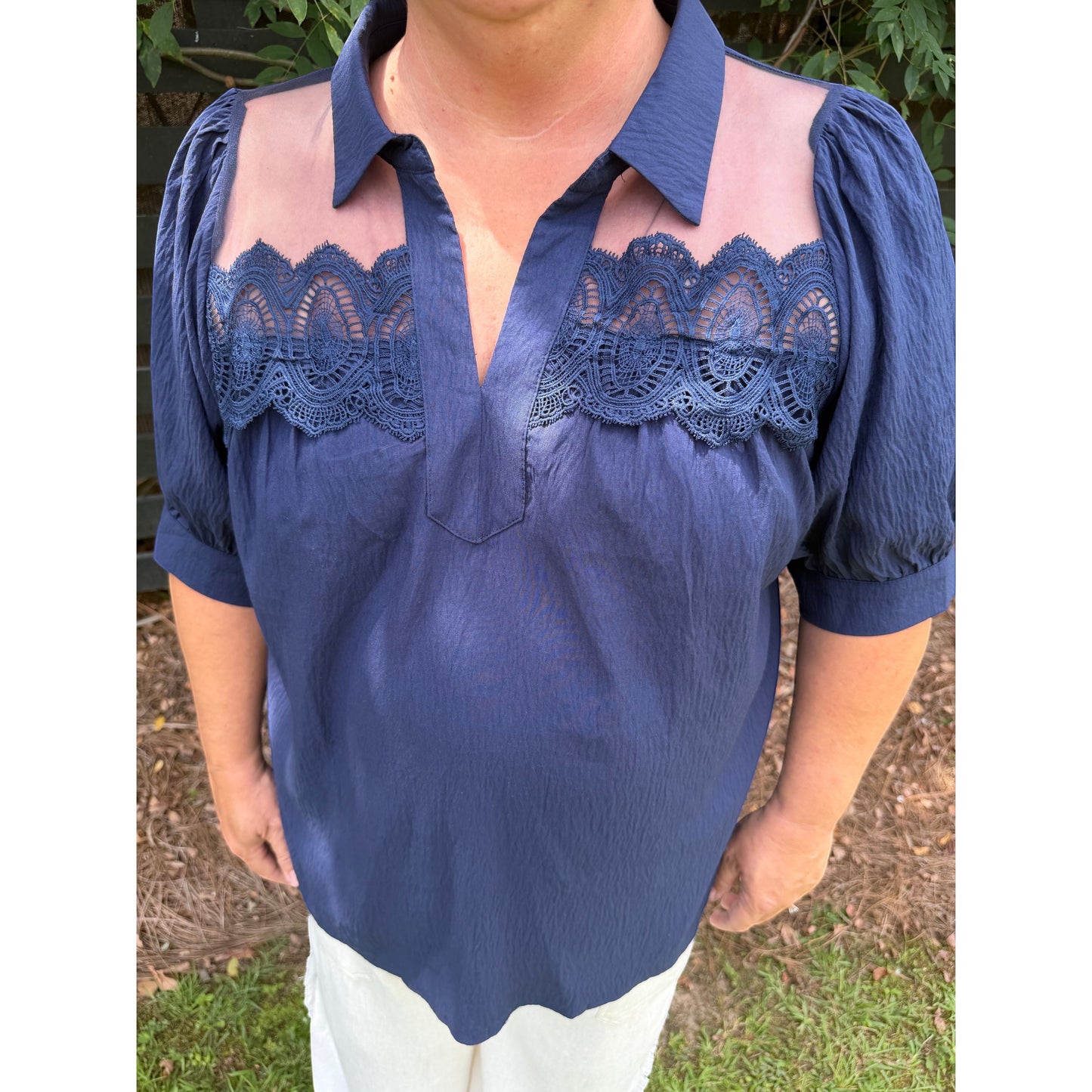 Annie Ks Boutique navy blouse with short puff sleeves, collared split neckline, and sheer lace shoulder panels.