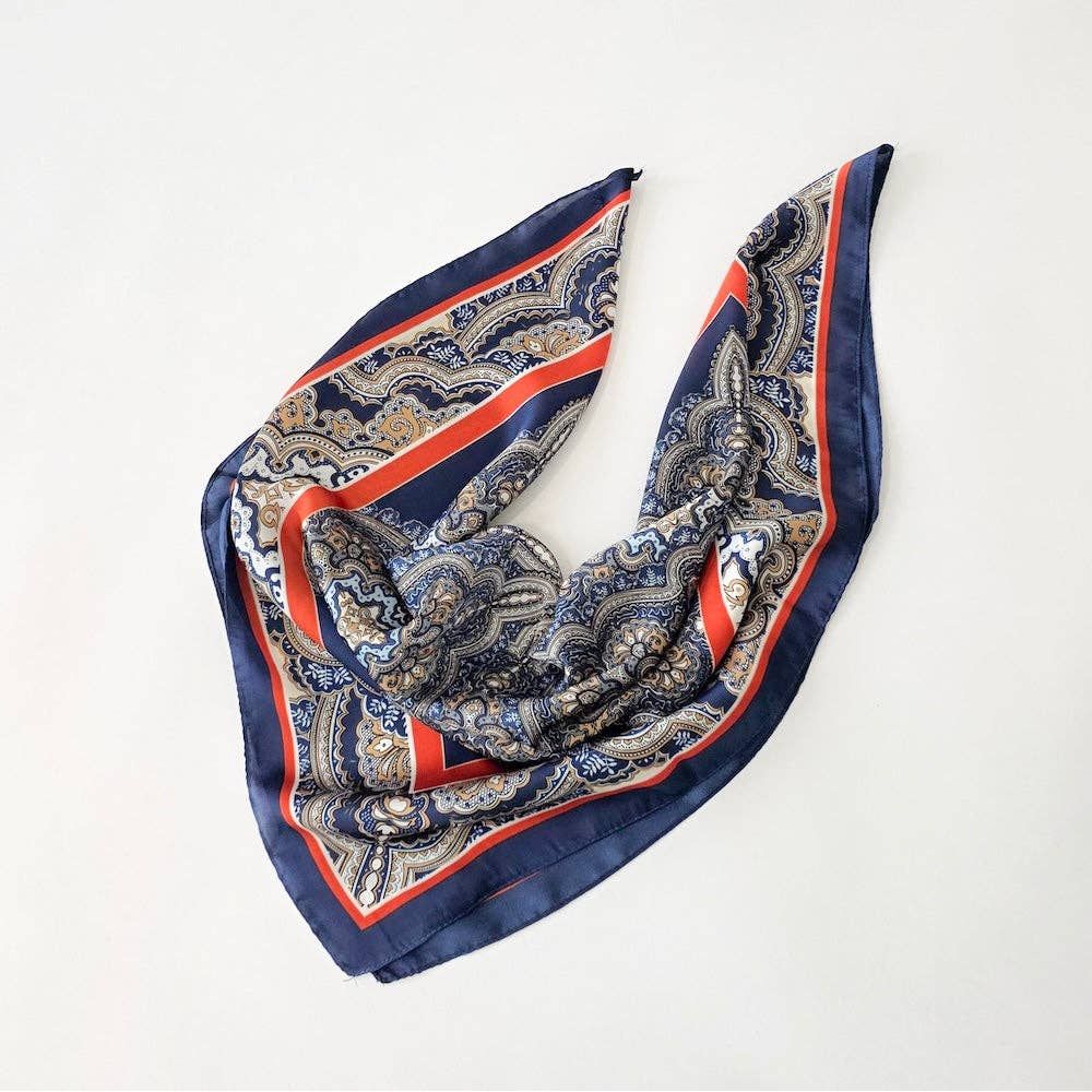 Annie Ks Boutique Alice square scarf in navy and rust with a geometric paisley pattern and soft woven fabric drape.