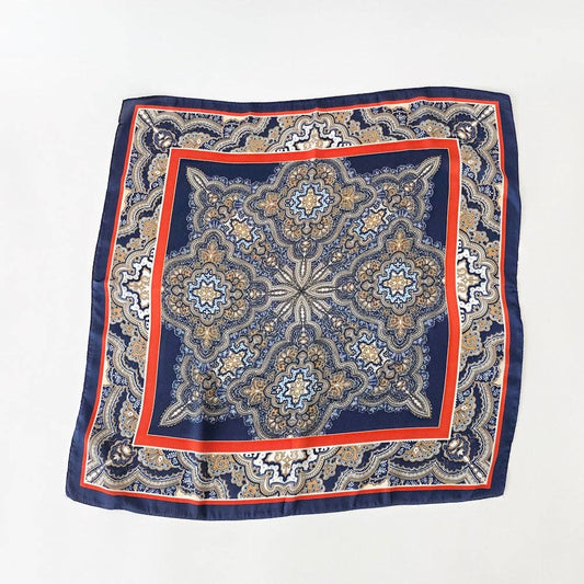 Annie Ks Boutique Alice square scarf in navy and rust with a detailed geometric paisley pattern on soft fabric.