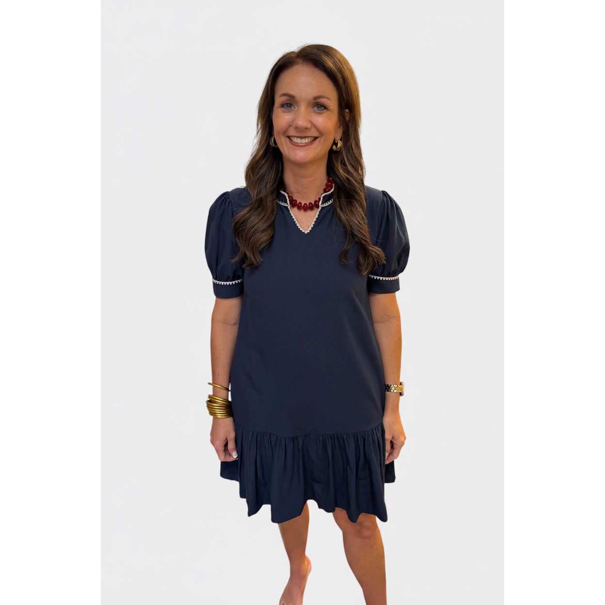 Annie Ks Boutique navy shift dress with puff sleeves, contrast embroidery, and a relaxed A-line silhouette.