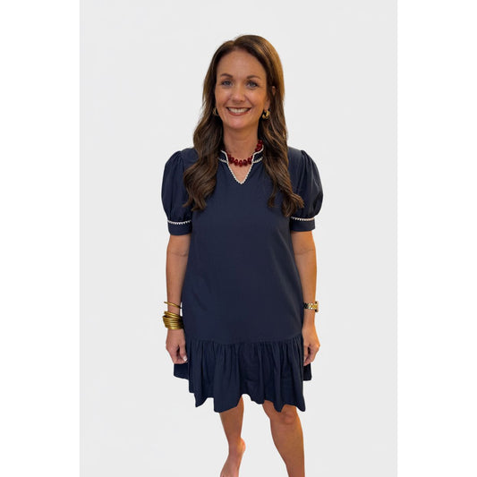 Annie Ks Boutique navy shift dress with puff sleeves, contrast embroidery, and a relaxed A-line silhouette.