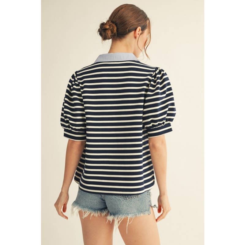 Back view of Annie Ks Boutique navy striped short sleeve knit top with a contrast collar worn with denim shorts.