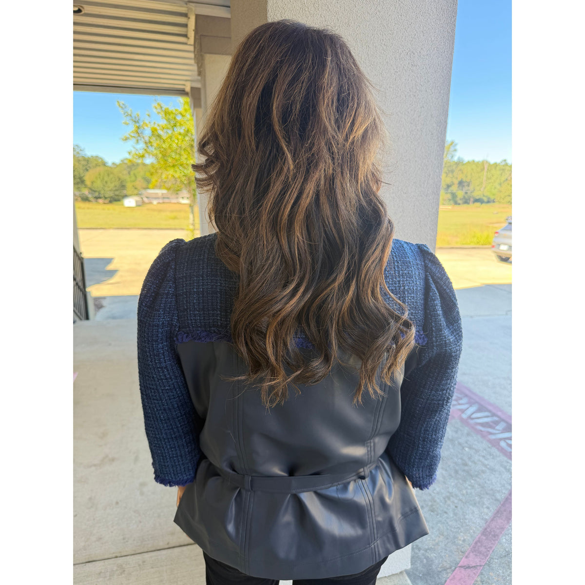 Back view of Annie Ks Boutique navy tweed and faux leather jacket with belted waist and three-quarter sleeves