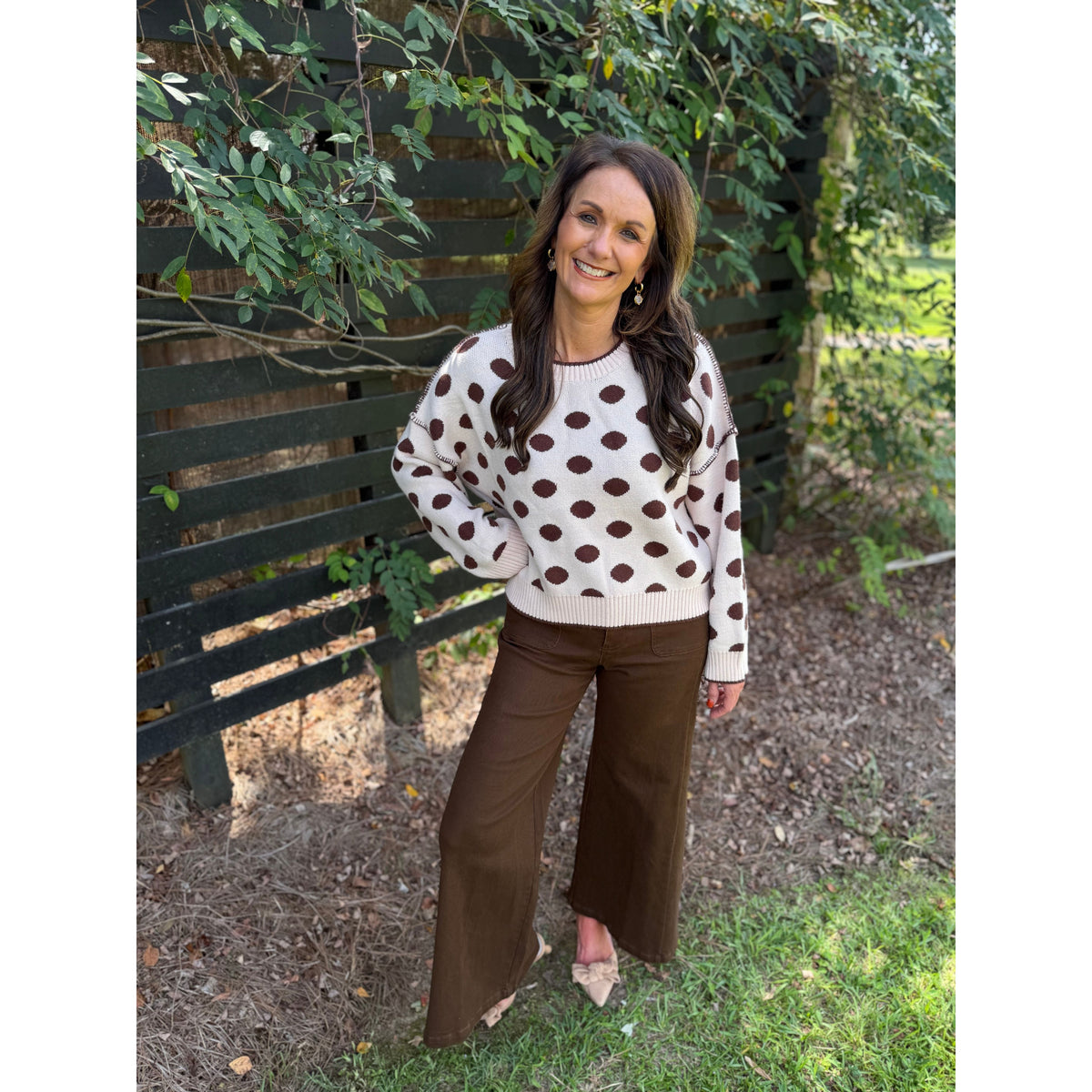 Annie Ks Boutique loose fit oatmeal sweater with brown polka dots worn by a woman outdoors
