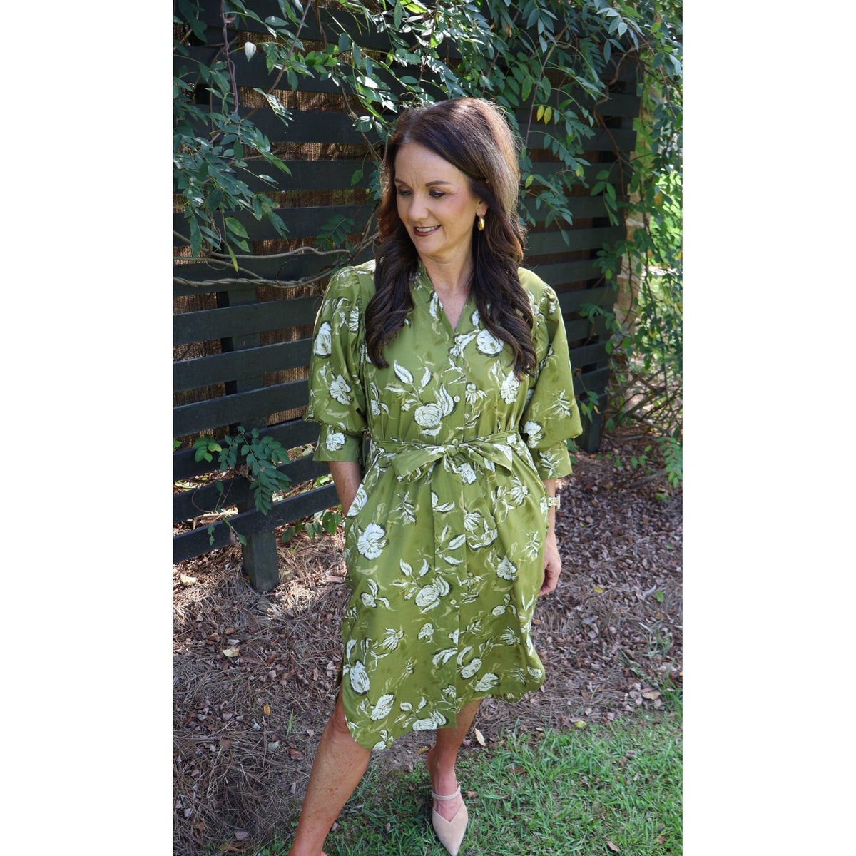 Annie Ks Boutique golden olive floral cotton midi dress with V-neck, half sleeves, and self-tie belt worn by a woman.