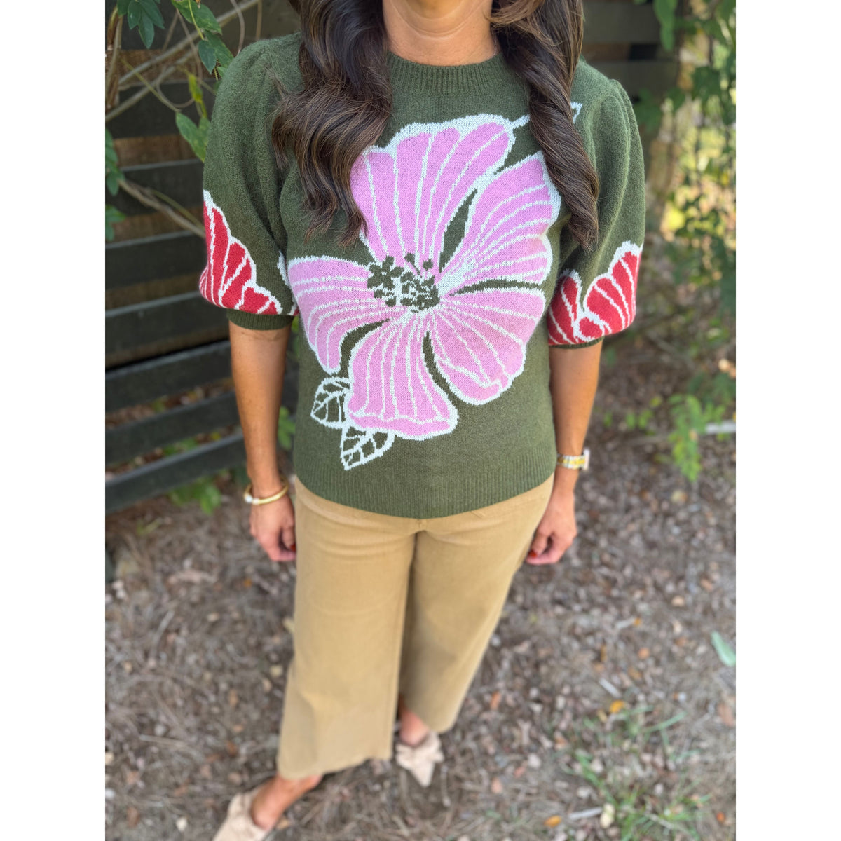 Annie Ks Boutique olive sweater with pink floral print and puff sleeves worn with tan trousers