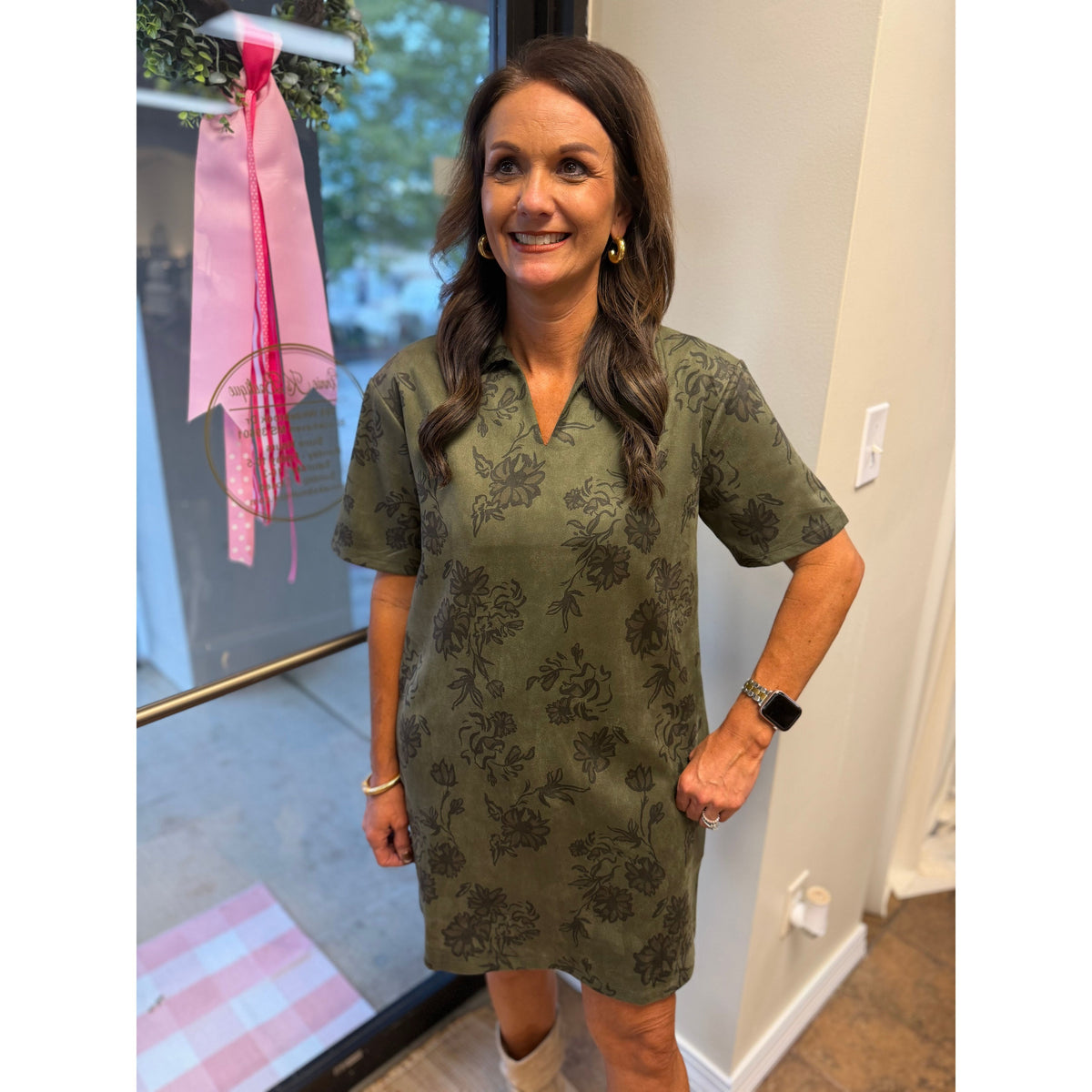 Annie Ks Boutique olive faux suede mini dress with a floral print, structured collar, and short sleeves on a woman