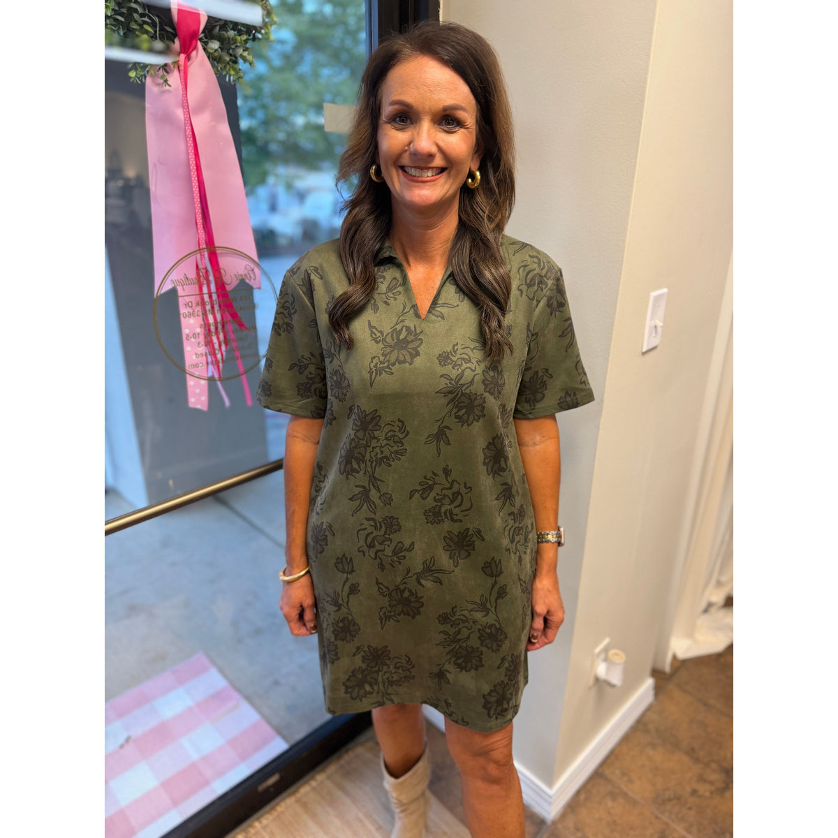 Annie Ks Boutique olive faux suede mini dress with a floral print, structured collar, and short sleeves on a woman.