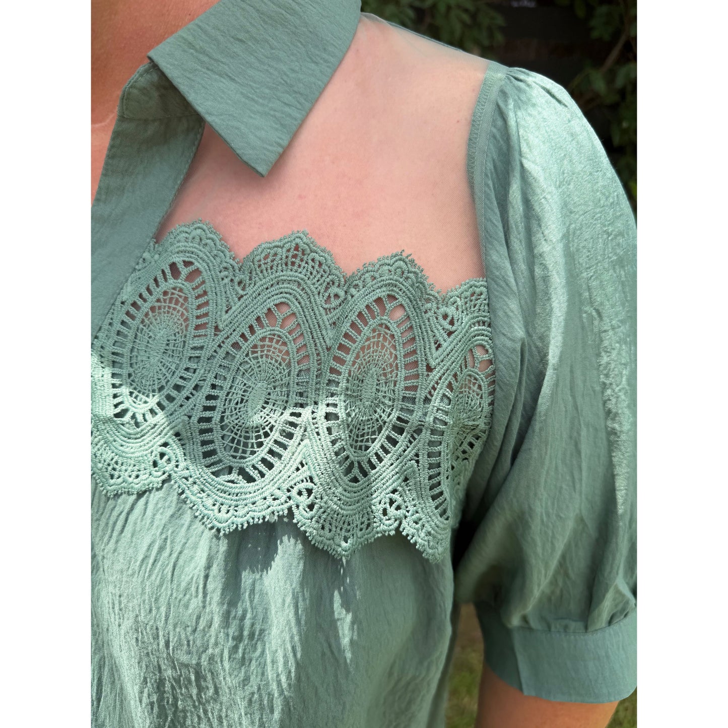 Annie Ks Boutique olive blouse featuring intricate lace trim, a collared neckline, and sheer mesh shoulder panels.