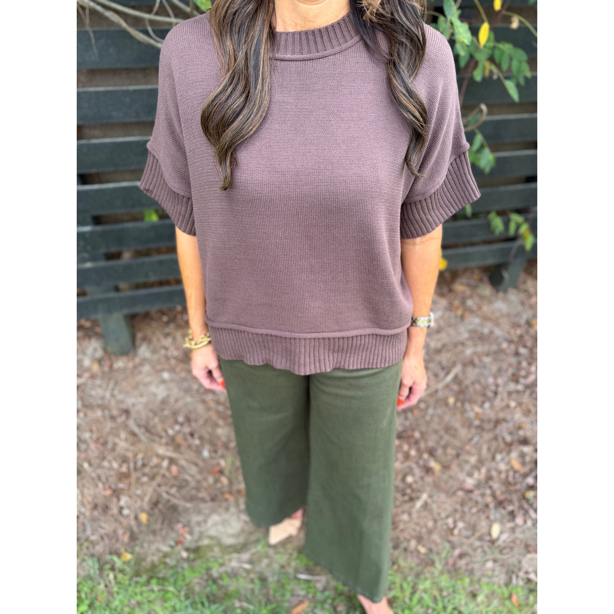Annie Ks Boutique olive wide-leg trousers paired with a brown short-sleeve knit sweater on a model