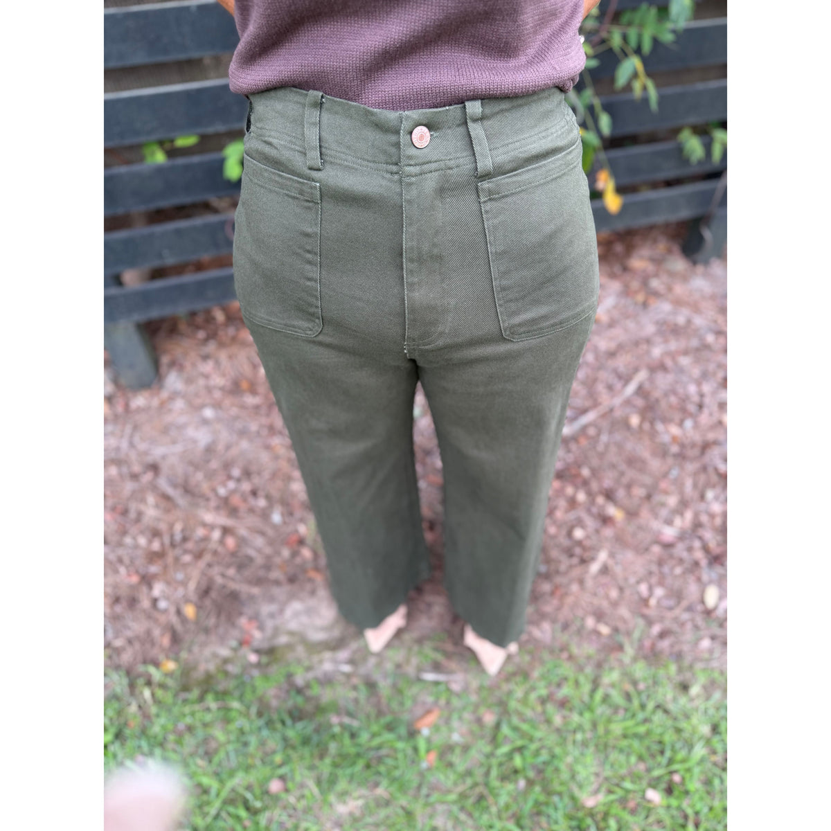 Annie Ks Boutique olive wide-leg trousers featuring front patch pockets, zip-fly closure, and cotton-knit fabric.