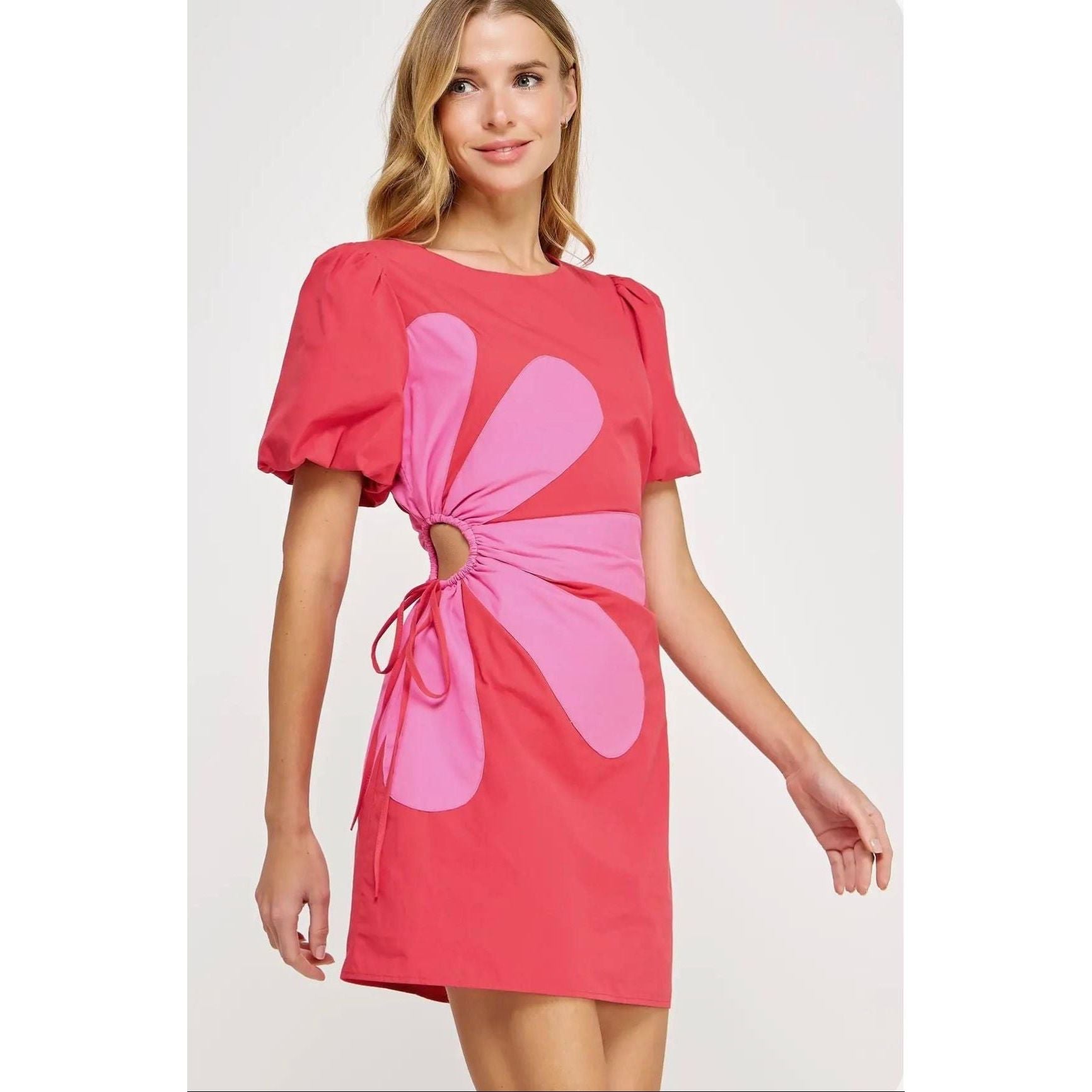 Annie Ks Boutique Primrose mini dress in pink cotton with puff sleeves, side cutout, and floral patchwork appliqué.
