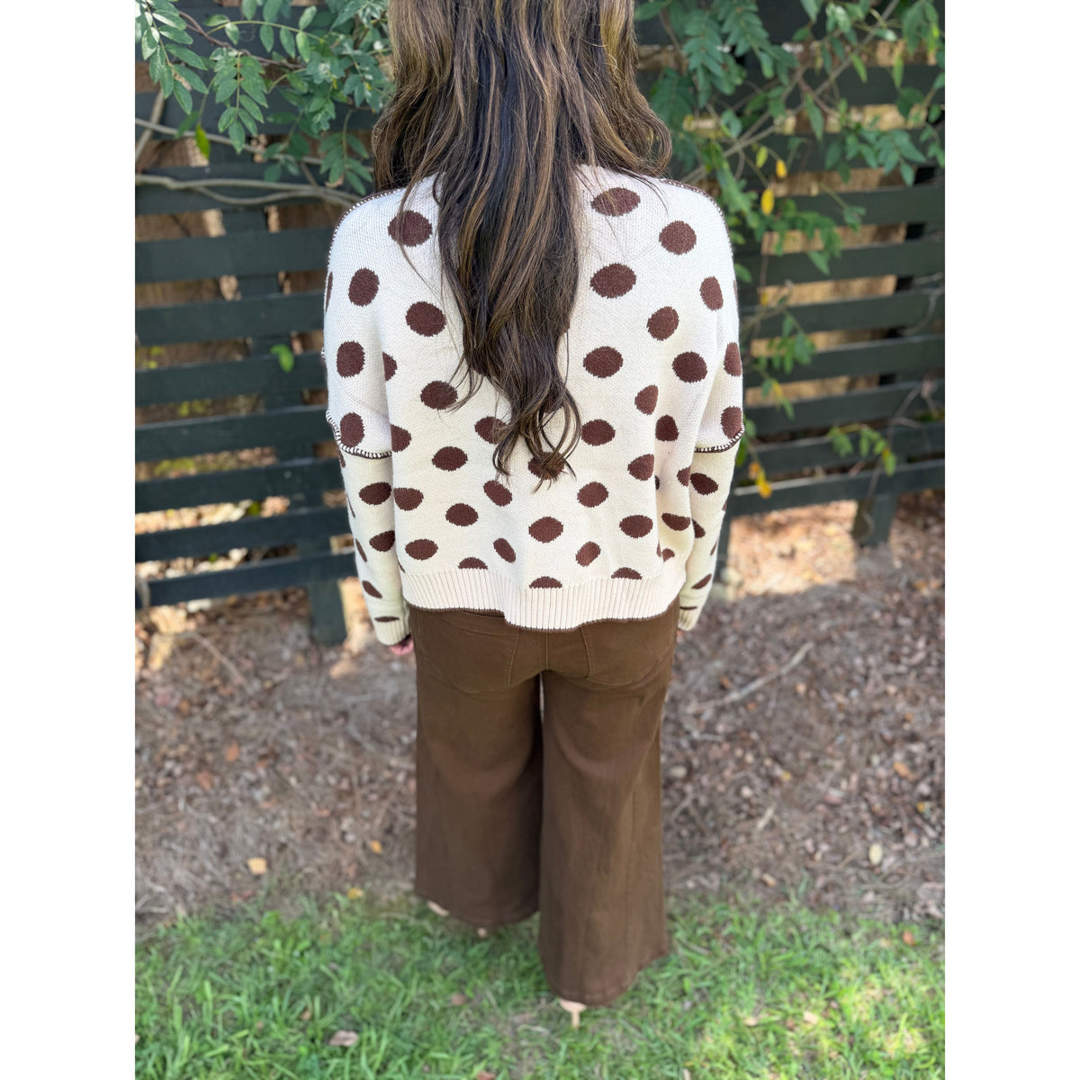 Annie Ks Boutique oatmeal and coffee polka dot loose fit sweater worn by a woman with long hair, back view