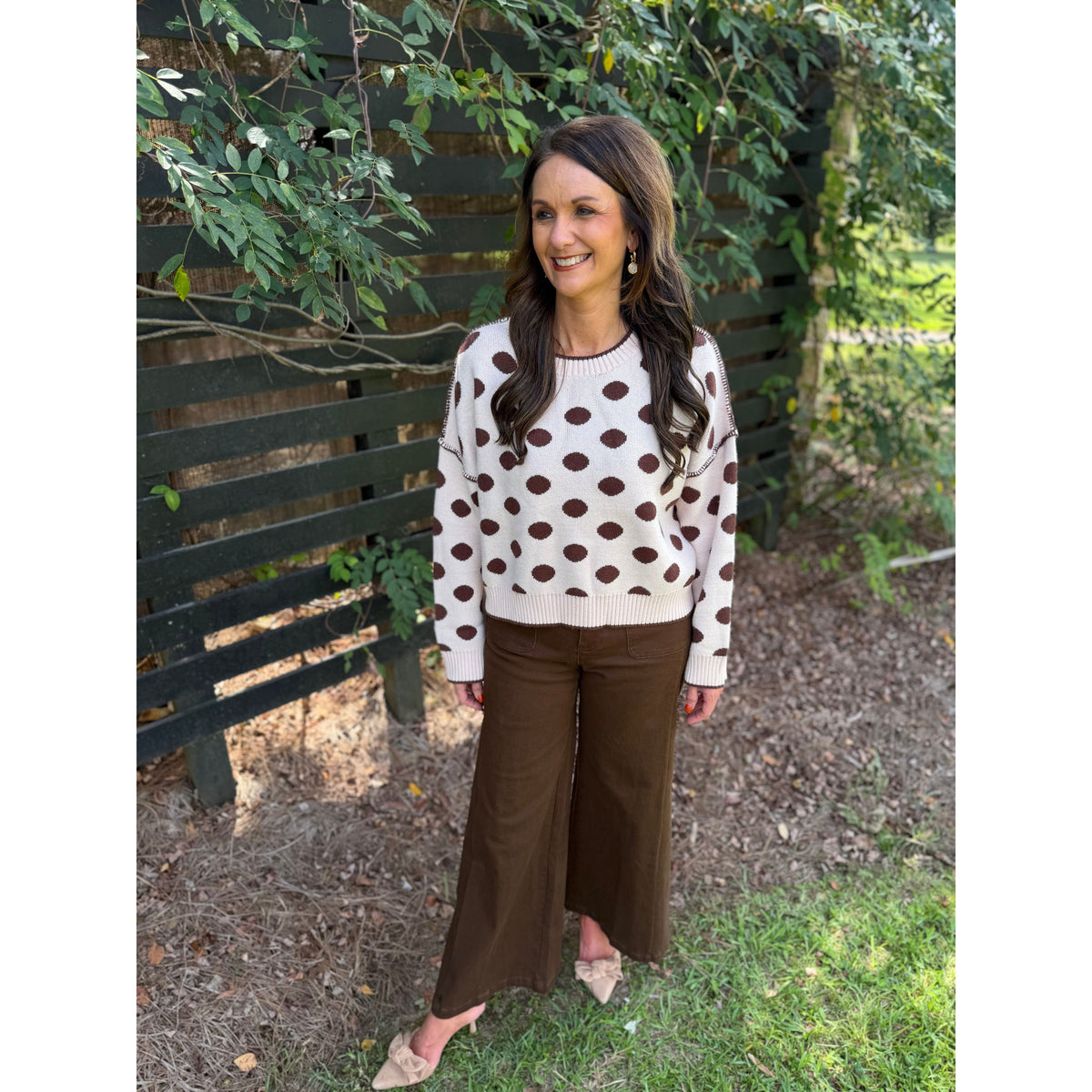 Annie Ks Boutique oatmeal and coffee polka dot loose fit sweater worn by a woman outdoors