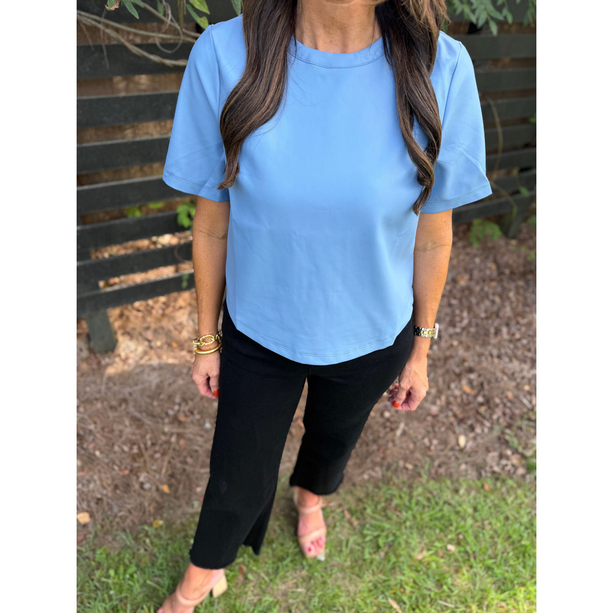 Annie Ks Boutique powder blue faux leather short-sleeve top with a crew neckline worn with black trousers