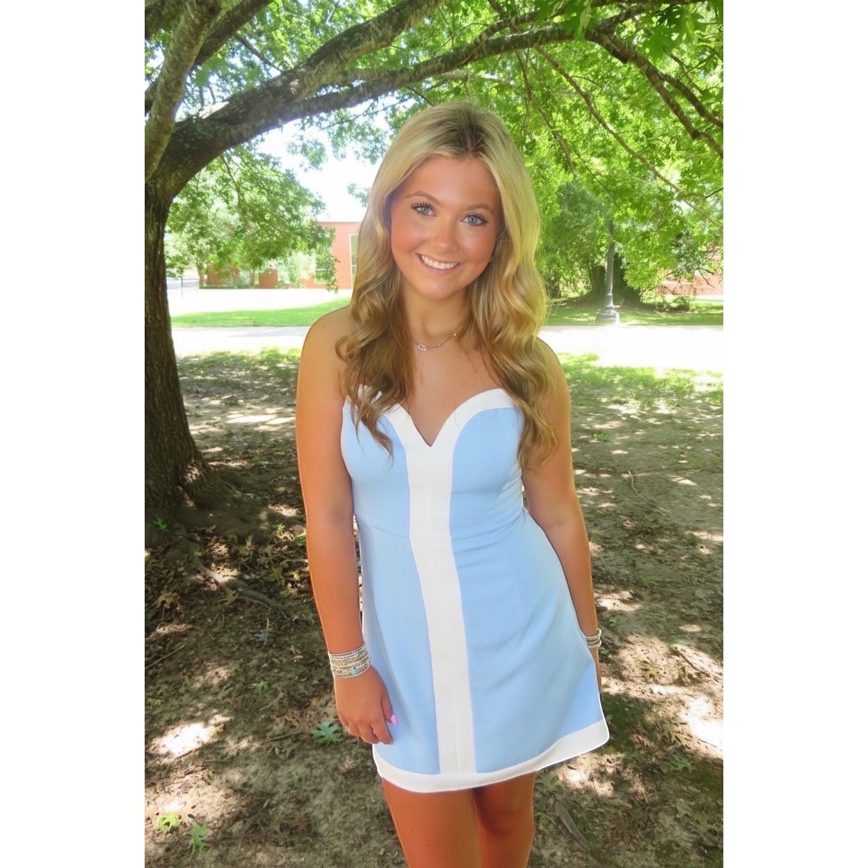 Annie Ks Boutique powder blue strapless romper dress with white paneling and sweetheart neckline worn by a model