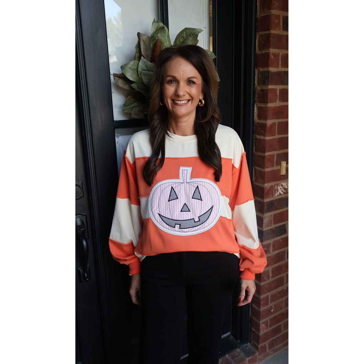 Annie Ks Boutique orange and cream color-block pullover with a large patchwork pumpkin appliqué for fall fashion.