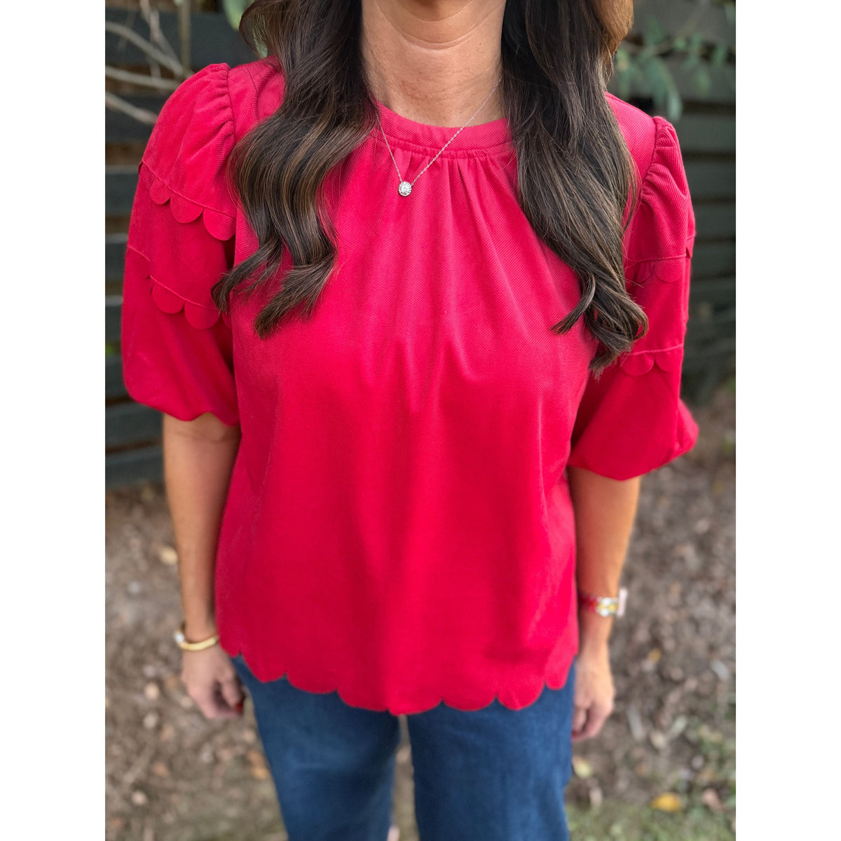 Annie Ks Boutique red corduroy top with bubble sleeves and scalloped hemline worn with blue jeans