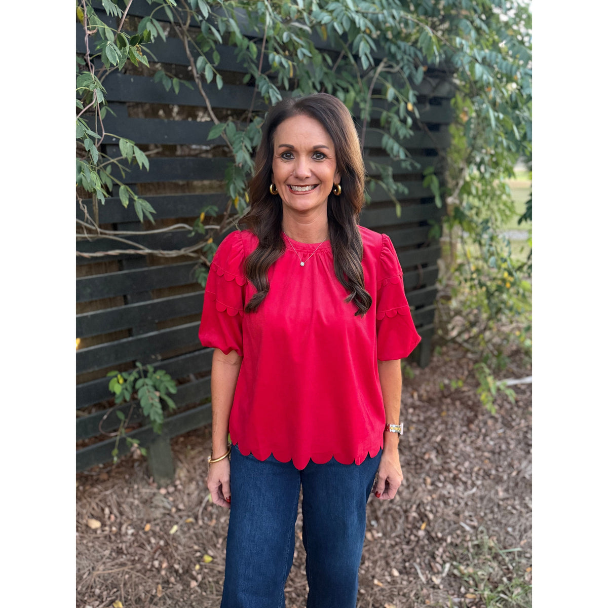 Annie Ks Boutique red corduroy top with bubble sleeves and scalloped hem worn by a woman outdoors.