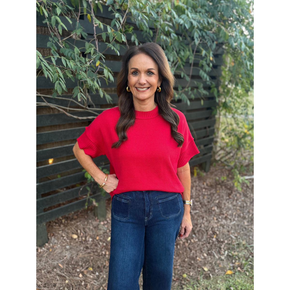 Annie Ks Boutique red crew neck sweater with drop-shoulder half sleeves worn by a woman with dark wavy hair