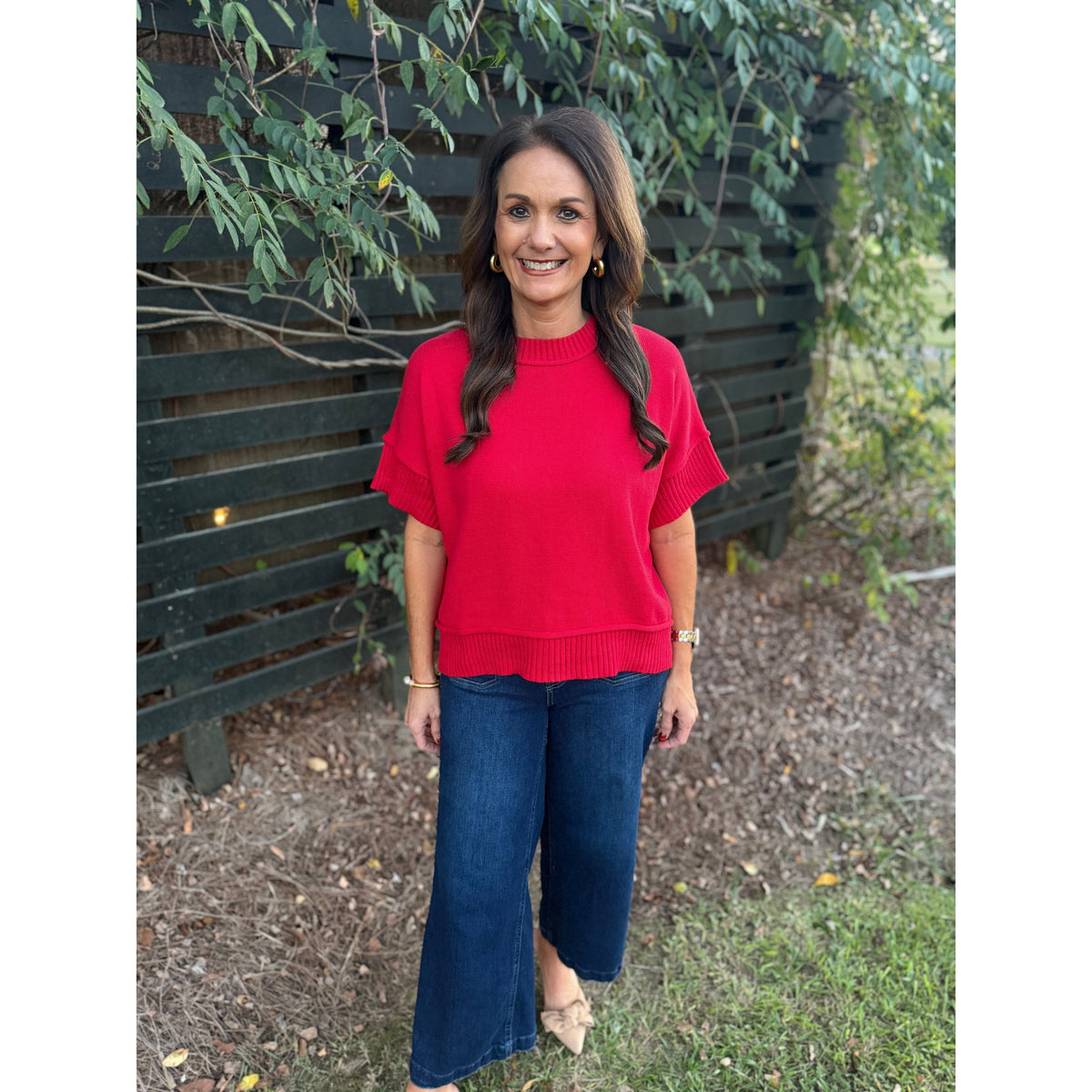 Annie Ks Boutique red half-sleeve crew neck sweater with dropped shoulders worn with dark blue denim jeans
