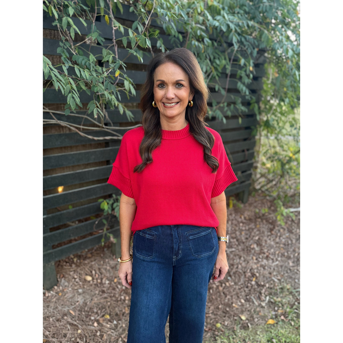 Annie Ks Boutique red crew neck sweater with drop-shoulder half sleeves worn by a woman with dark wavy hair