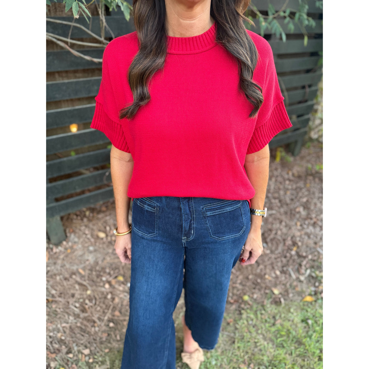 Annie Ks Boutique red crew neck sweater with drop-shoulder half sleeves worn with dark blue denim jeans