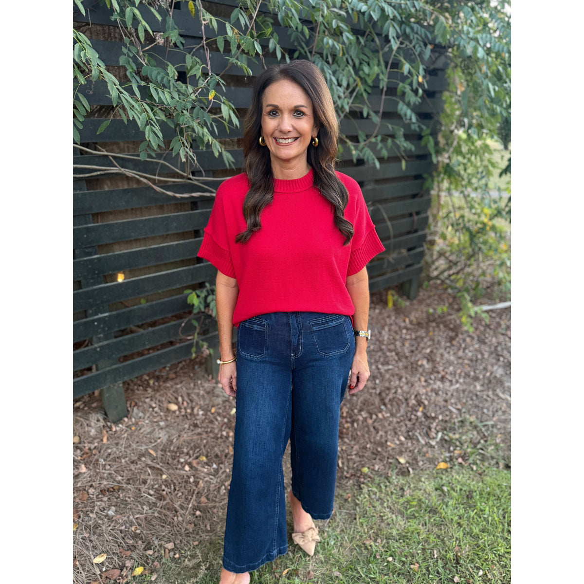 Annie Ks Boutique red crew neck sweater with drop shoulders and half sleeves worn with dark denim jeans