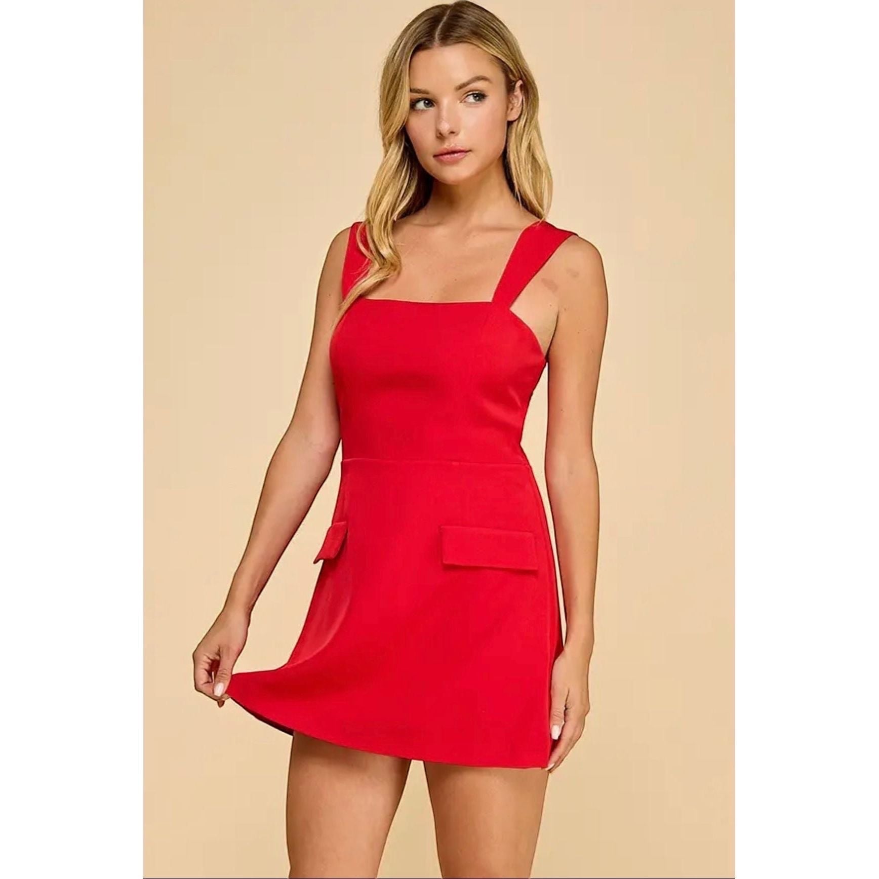 Annie Ks Boutique red mini skort romper with a straight neckline, wide straps, and faux flap pockets.