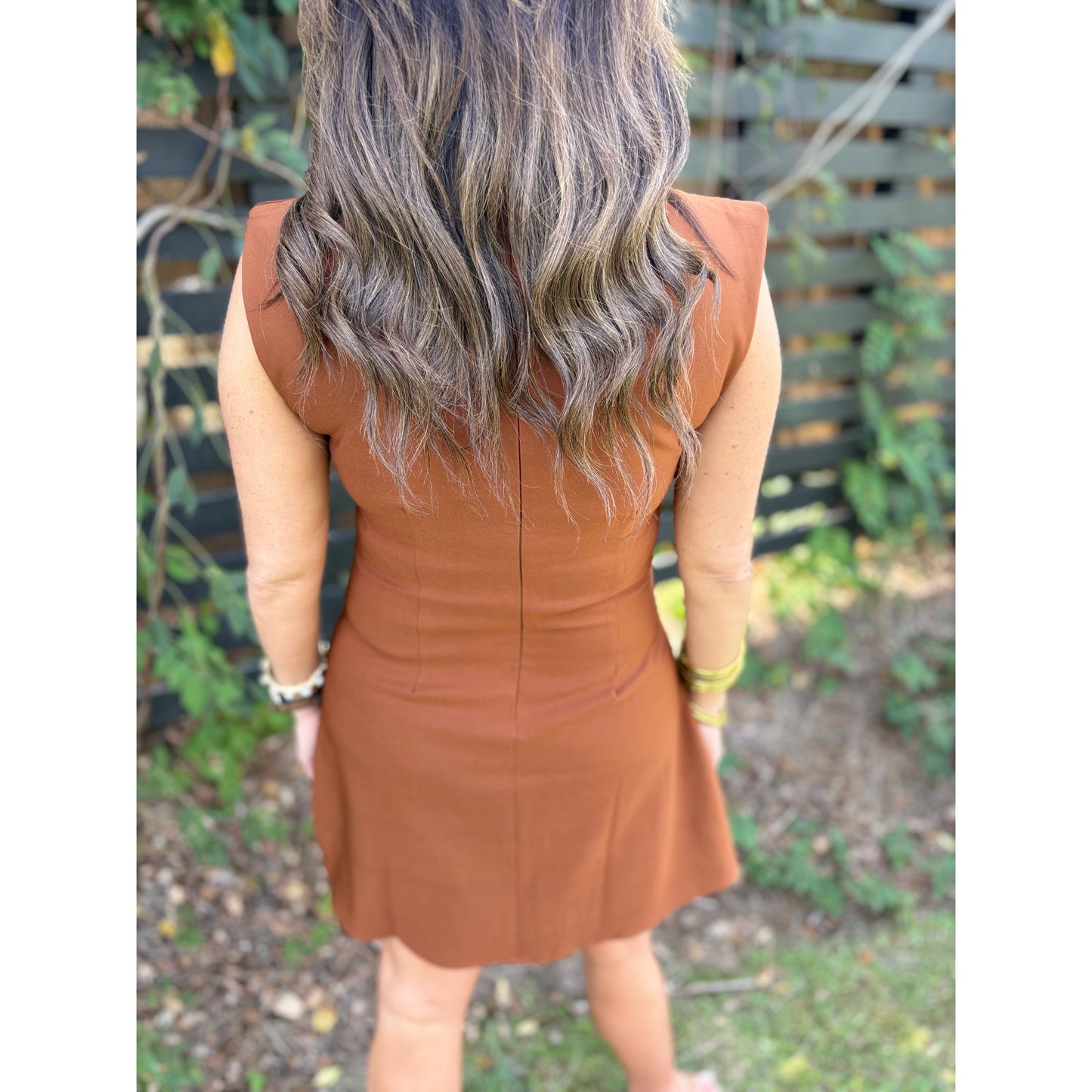 Back view of Annie Ks Boutique Riley Mini Dress in rust brown featuring a structured sleeveless tailored silhouette