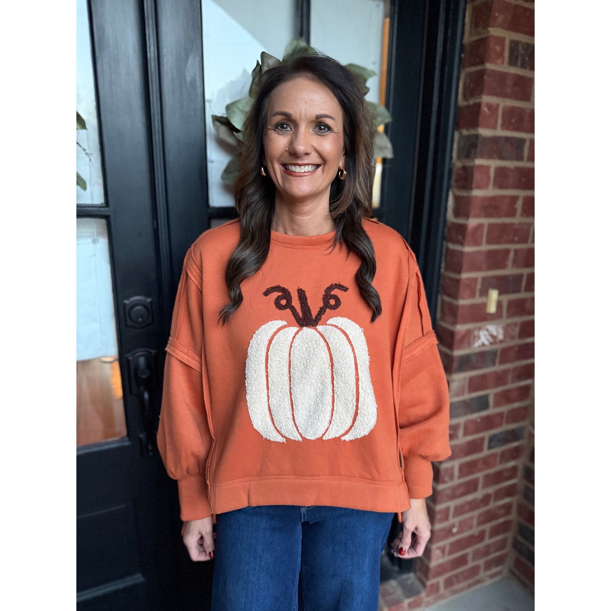 Annie Ks Boutique vintage rust pullover with a textured white pumpkin patch, worn by a woman in a casual setting.